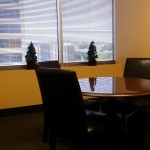 meeting room with yellow walls round table and window with a view