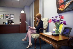woman sitting in a lobby reading a magazine