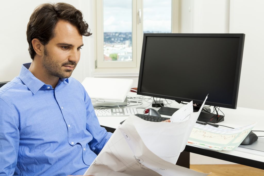 Young Man Reading Written Agreements For Work